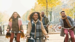 81393888 - smiling young friends bike riding on urban autumn street